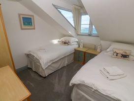 A bedroom with two beds and a window at Ocean Gem in Carbis Bay