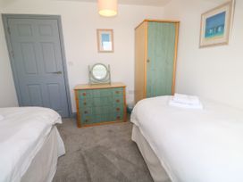 A bedroom with a dresser and wardrobe at Ocean Gem in Carbis Bay