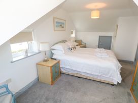 A bedroom with a bed and bedside lamp at Ocean Gem in Carbis Bay