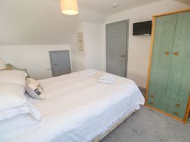 A bedroom with a bed and wardrobe at Ocean Gem in Carbis Bay