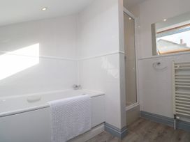 A bathroom with a bathtub and shower at Ocean Gem in Carbis Bay