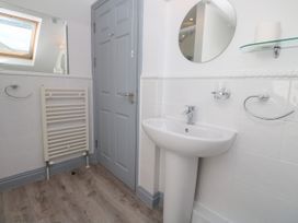 A bathroom with sink, mirror, and towel rail at Ocean Gem in Carbis Bay