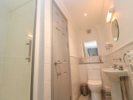 A bathroom with a shower, toilet, and sink at Ocean Gem in Carbis Bay