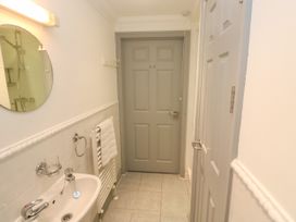 A bathroom with a sink and a mirror at Ocean Gem in Carbis Bay