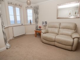 A living room with a sofa and table at Golva in Carbis Bay