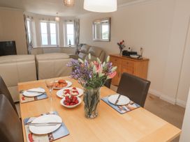A dining room with a table set for a meal at Golva in Carbis Bay