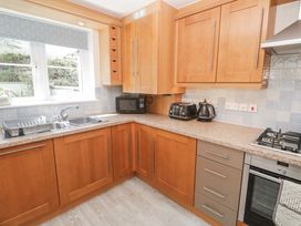 A kitchen with cabinets and appliances at Golva in Carbis Bay