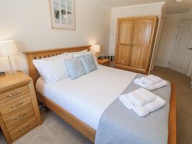 A bedroom with a bed and nightstand at Golva in Carbis Bay