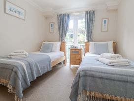 A bedroom with two beds and a window at Golva in Carbis Bay