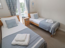 A bedroom with two single beds and a nightstand at Golva in Carbis Bay