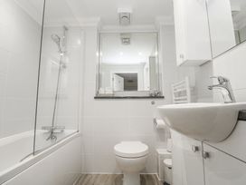A bathroom with a shower, bathtub, sink and toilet at Golva in Carbis Bay