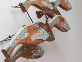 A close up of a wooden wall decoration with a distressed paint finish at Harbour View Carbis Bay