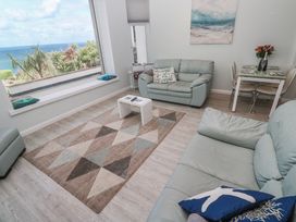 A living room with a coffee table and sofa at Island View in Carbis Bay