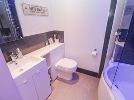 A bathroom with a sink, toilet, and shower at Island View in Carbis Bay