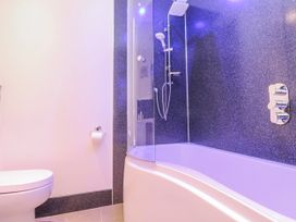 A bathroom with a bathtub and shower at Island View in Carbis Bay