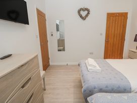 A bedroom with a bed and dresser at Island View in Carbis Bay
