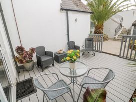 An outdoor seating area with chairs and a table at Island View in Carbis Bay