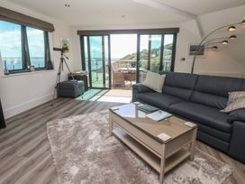A living room with a sofa and coffee table at Oceania in St Ives