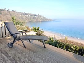 An outdoor space with a lounge chair overlooking the ocean at Sapphire in Carbis Bay