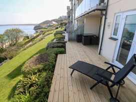 A deck with a lounge chair and view of the sea at Sapphire in Carbis Bay