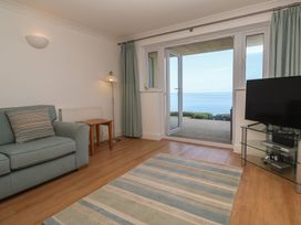 A living room with a sofa and a tv at Sapphire in Carbis Bay