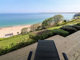 A view of the ocean and beach from a deck at Sapphire in Carbis Bay