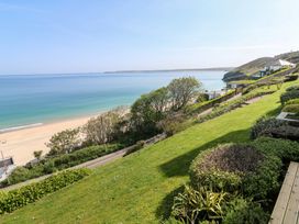 A beach view with grass and trees at Sapphire in Carbis Bay
