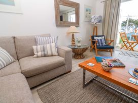 A living room with a sofa and coffee table at Sea Breeze in Carbis Bay