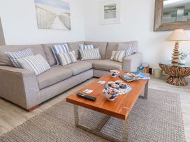 A living room with a sofa and coffee table at Sea Breeze in Carbis Bay