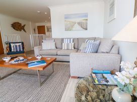 A living room with a sofa and coffee table at Sea Breeze in Carbis Bay