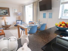 A dining room with a table set for a meal at Sea Breeze in Carbis Bay
