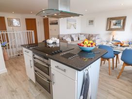 A kitchen with an island and dining area at Sea Breeze in Carbis Bay