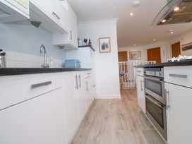 A kitchen with cabinets and appliances at Sea Breeze Carbis Bay