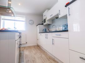 A kitchen with a sink and microwave at Sea Breeze in Carbis Bay
