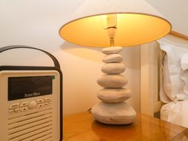 A lamp and radio on a nightstand at Sea Breeze in Carbis Bay