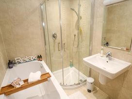A bathroom with a bathtub and shower at Sea Breeze in Carbis Bay