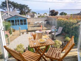 An outdoor area with a table and chairs at Sea Breeze, Carbis Bay