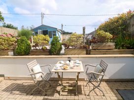 A garden with a table and chairs set up for tea at Sea Breeze in Carbis Bay