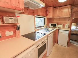 A kitchen with appliances and countertop at Squirrels Leap Number 29, Burnside Park near Keswick