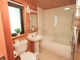 A bathroom featuring a tub, sink, and toilet at Squirrels Leap Number 29, Burnside Park near Keswick