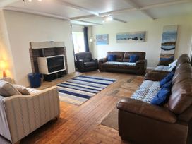 A living room with sofas and a fireplace at ASTA COTTAGE in Cresswell