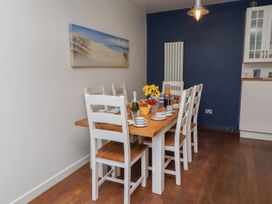 A dining room with a table set for meals at ASTA COTTAGE Cresswell