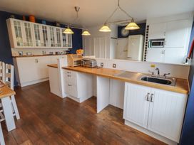 A kitchen with cabinets, sink, and appliances at ASTA COTTAGE in Cresswell