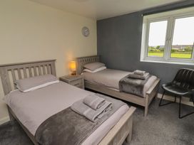 A bedroom with two single beds and a window at ASTA COTTAGE Cresswell