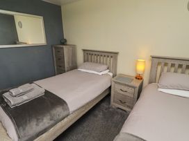 A bedroom with two beds and a chest of drawers at ASTA COTTAGE in Cresswell