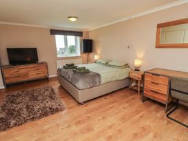 A bedroom with a bed and television at ASTA COTTAGE in Cresswell