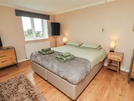 A bedroom with a bed and nightstands at ASTA COTTAGE in Cresswell