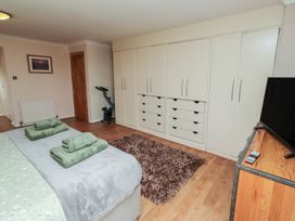 A bedroom with a bed, closet, and television at ASTA COTTAGE in Cresswell