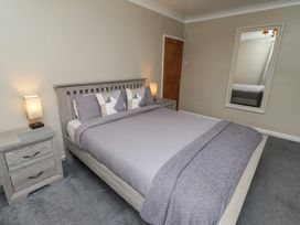 A bedroom with a bed and bedside tables at ASTA COTTAGE Cresswell