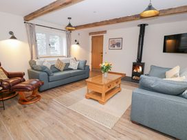 A living room with sofas and a fireplace at Merddwr in Cerrigydrudion